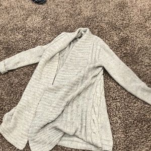 This is a gray cardigan. You can wear it in the house and outside.